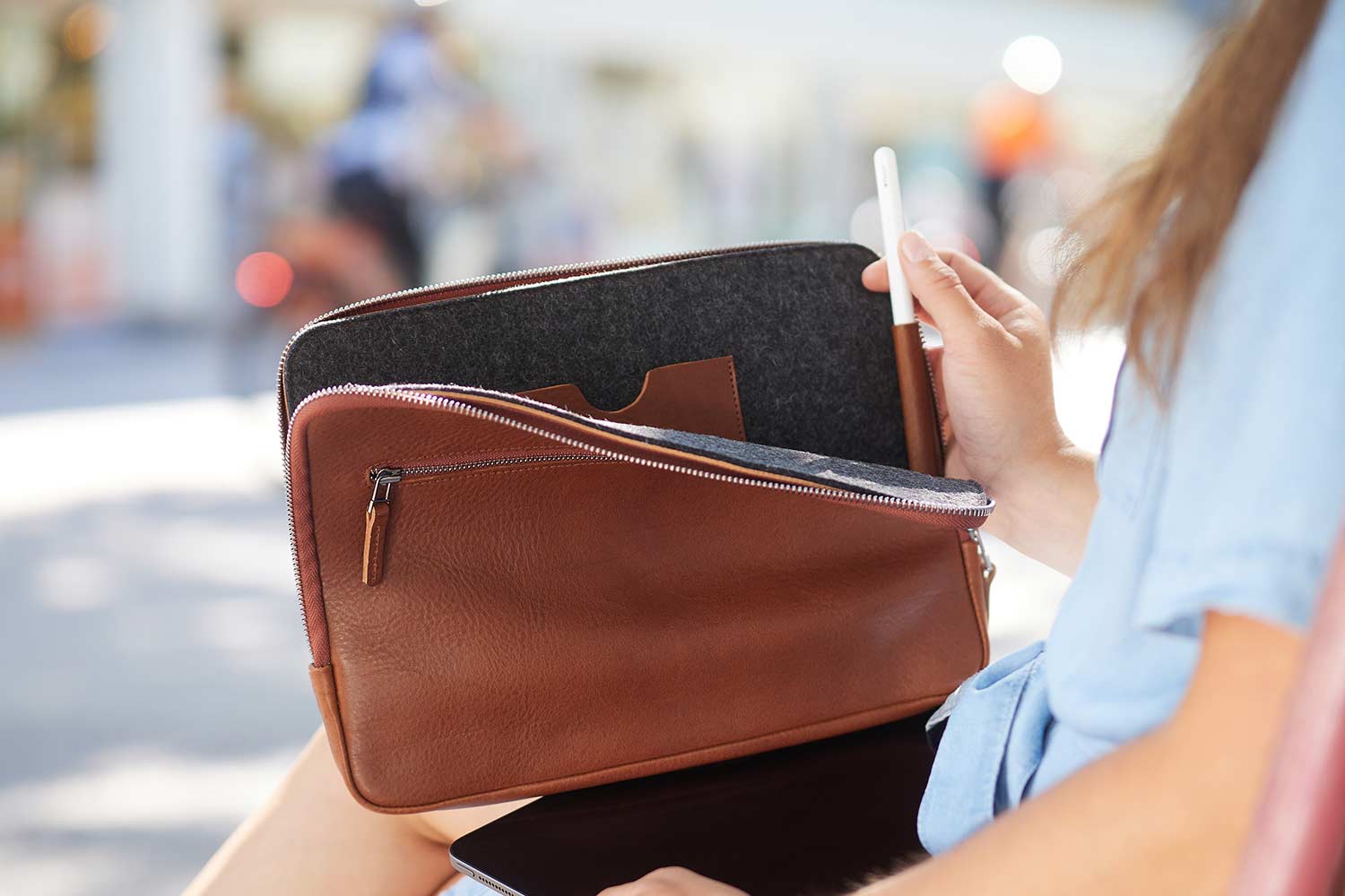A Far sits in front of an open leather iPad case from Good Wilhelm