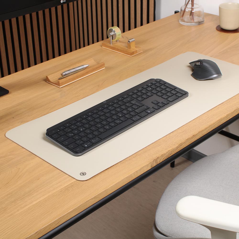 A white linoleum desk pad in white lies on a desk