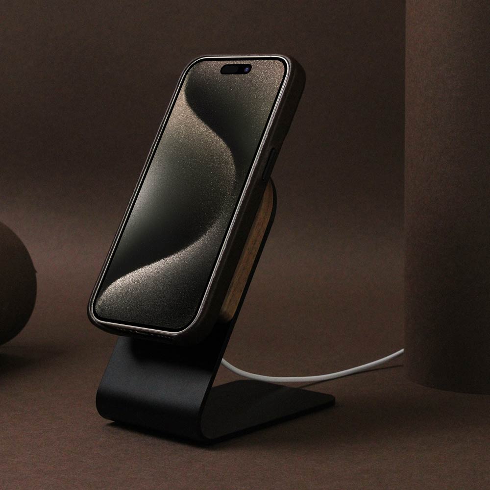 High-quality iPhone case in dark brown charging on the Magsaf stand