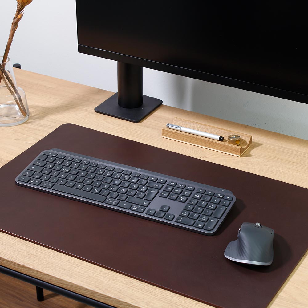 Dark brown leather desk pad on wooden table