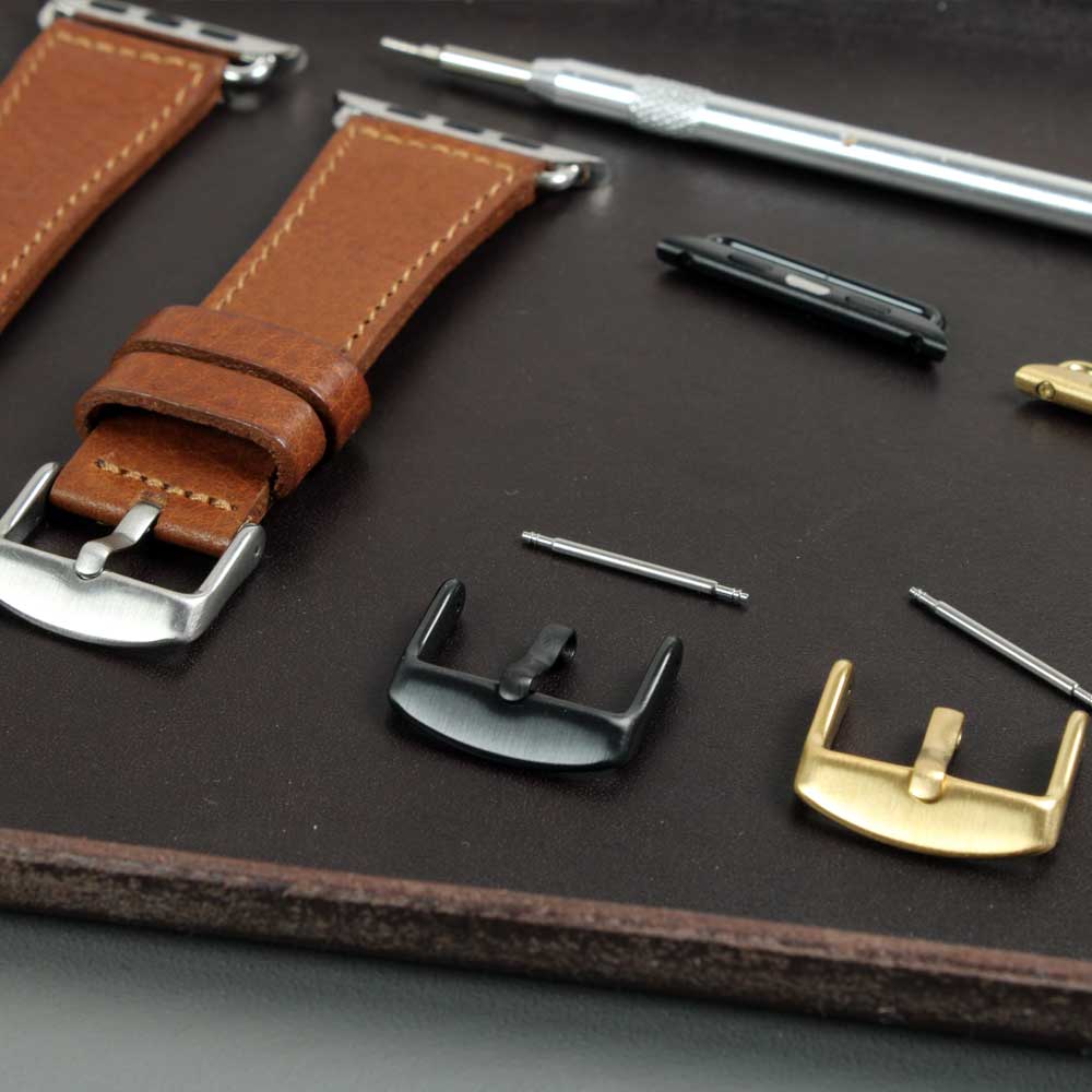There are three watch clasps in stainless steel, black and gold on a Tiasch