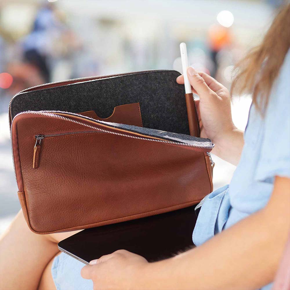 A woman puts an Apple Pencil into an iPad case