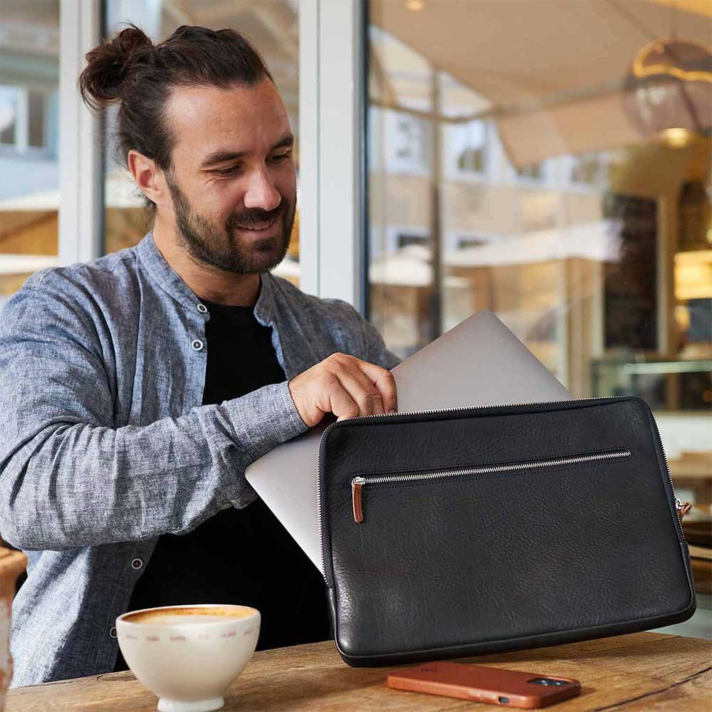 Man with black Macbook sleeve from Goodwilhelm