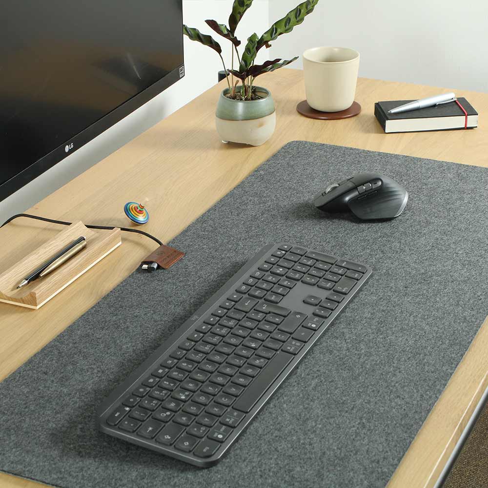 A felt desk pad lies on a table