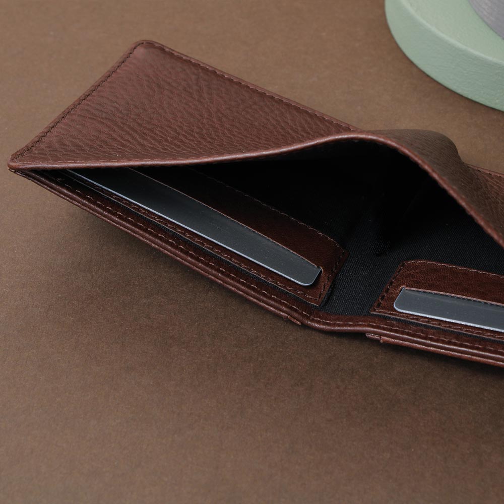 Dark brown men's wallet with coin pocket and card pocket in the bill compartment, high-quality workmanship, side view on concrete base - Good Wilhelm brand