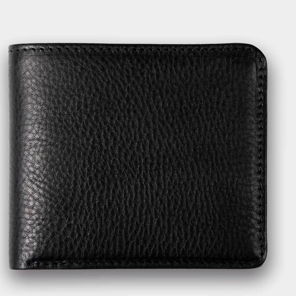 Closed wallet made from vegetable-tanned leather in black on a white background