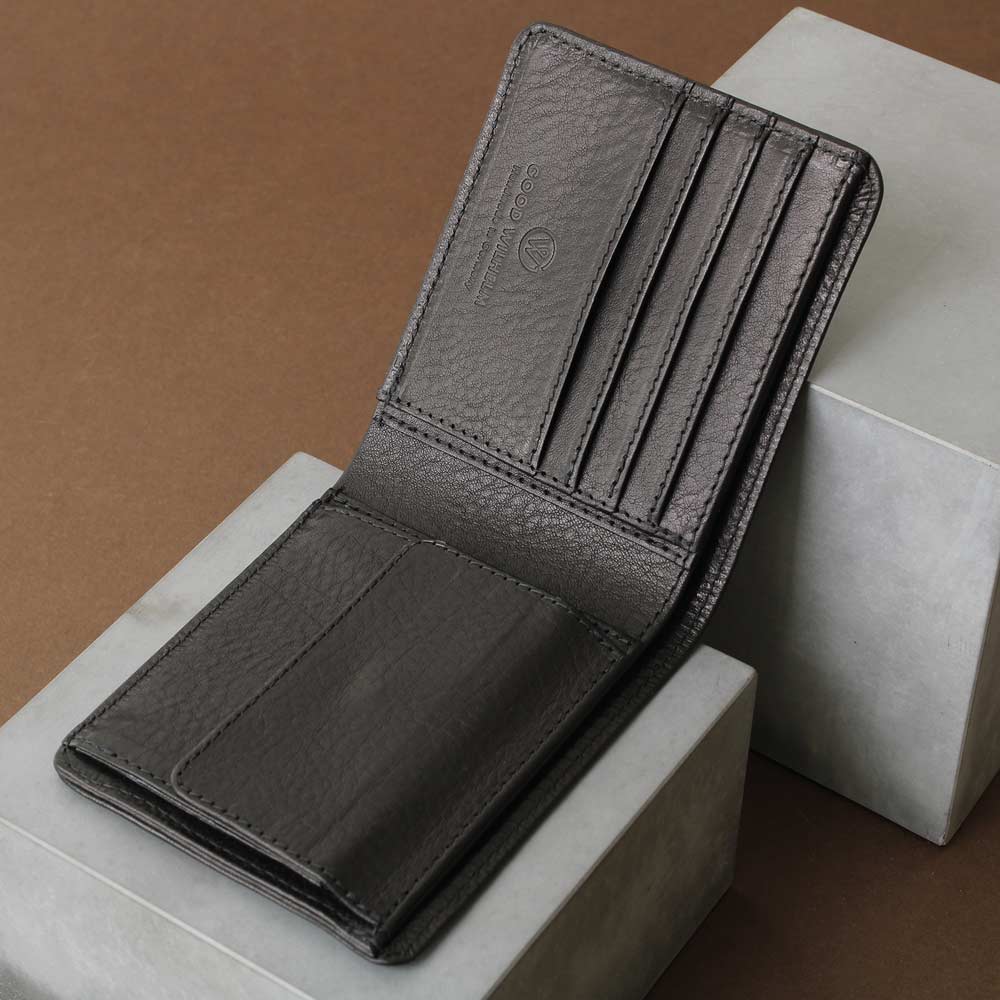 Black men's wallet with coin compartment, bill compartment and card compartment for up to 6 cards, high-quality workmanship, side view on concrete base - Good Wilhelm brand